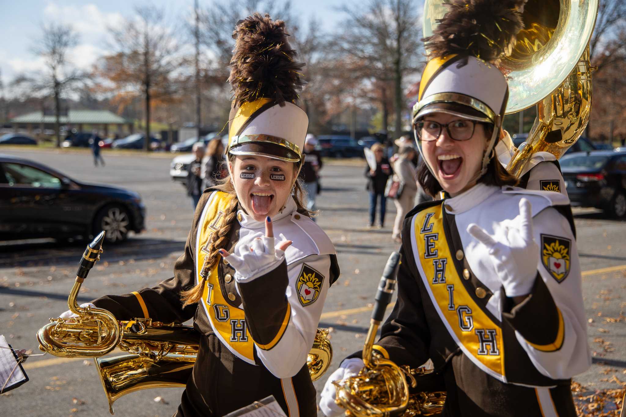 2 baritone saxophonists posing during tailgating