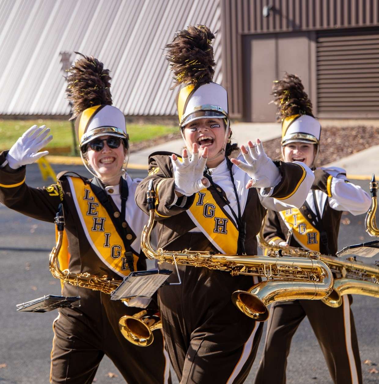 3 tenor saxophonists waving