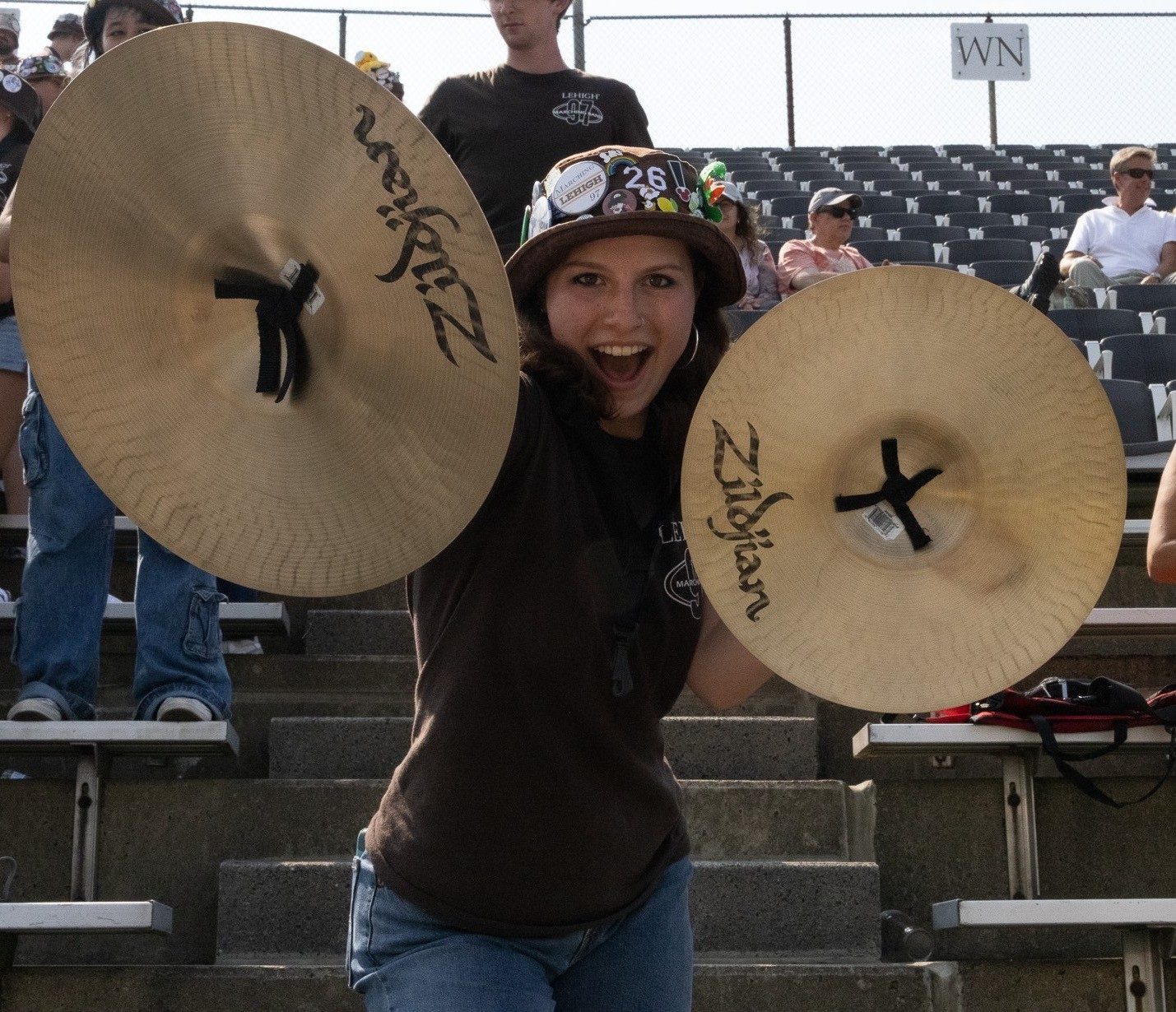 A 97 member posing with cymbals in her hands