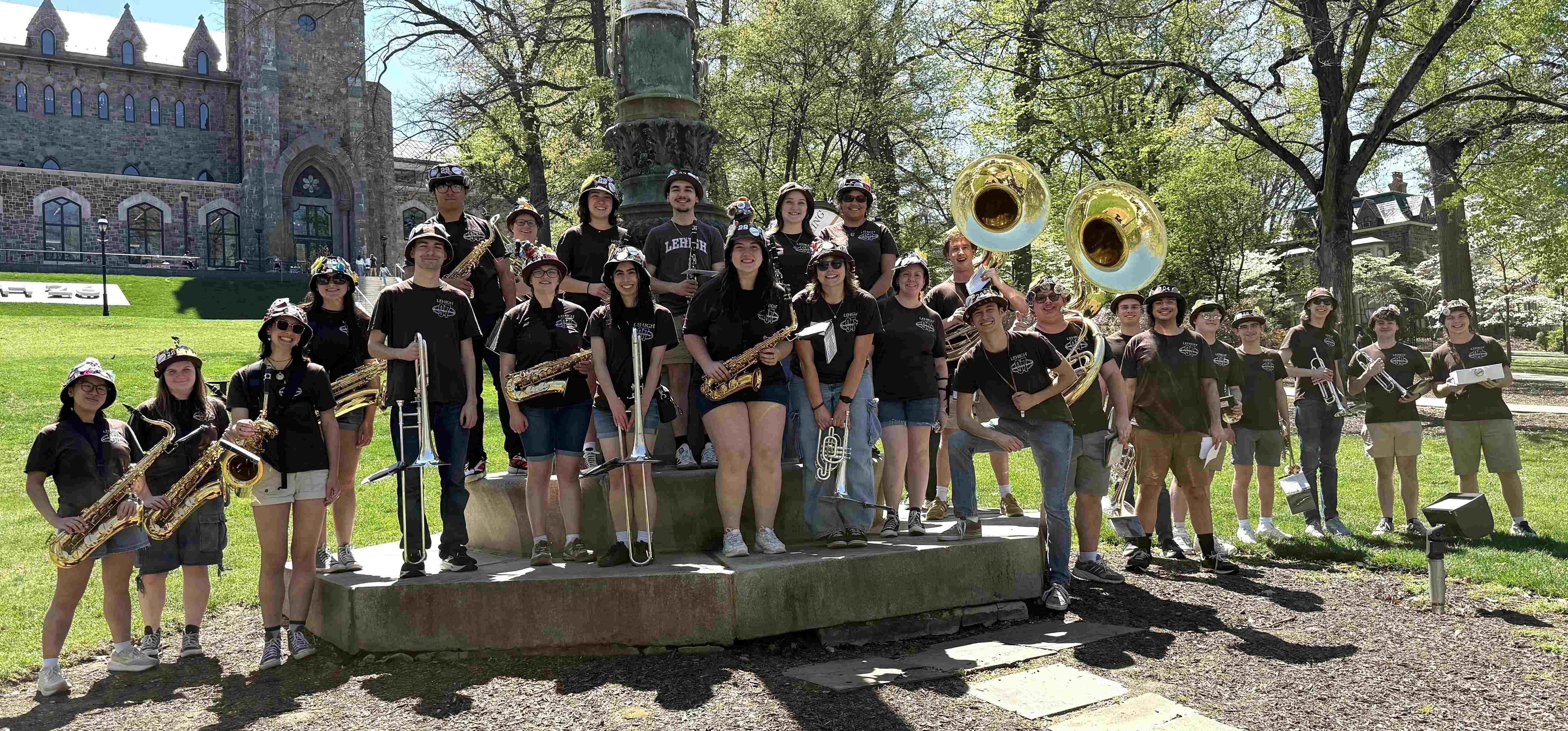 The band smiling in front of the University Center flagpole during Lehigh Fest