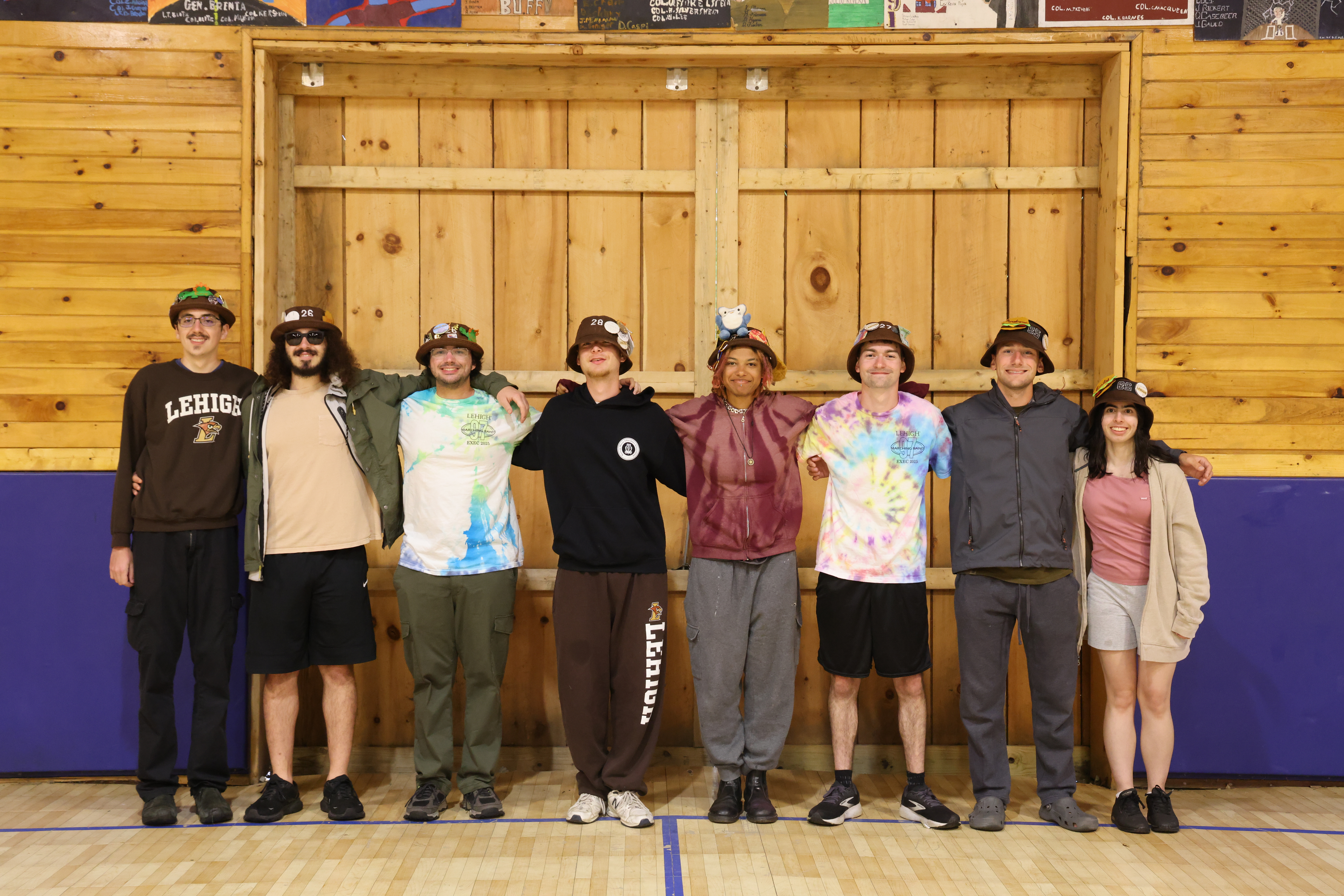 Rank 1 smiling with their arms around each other at band camp.