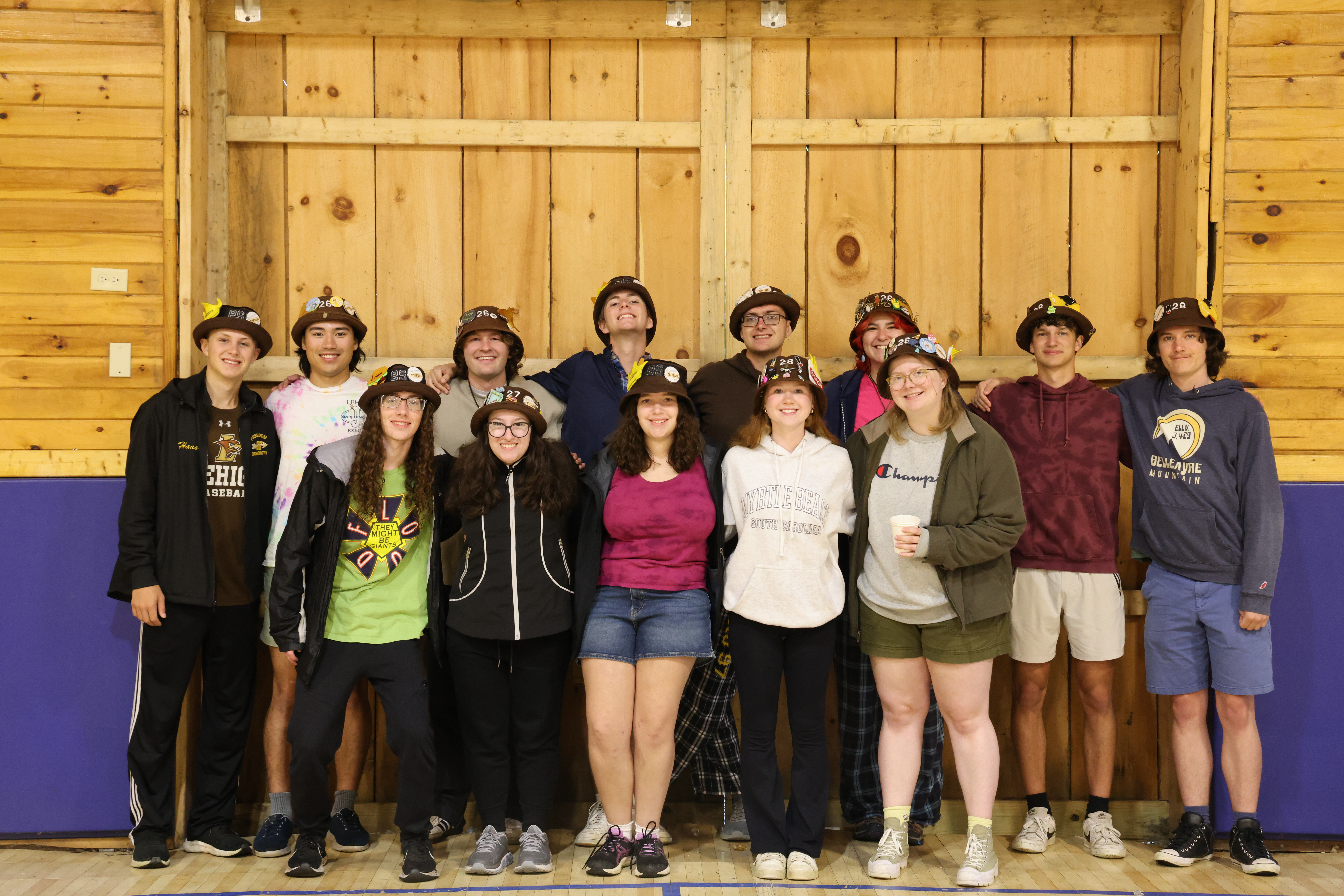 Ranks 3 and 12 in two rows, smiling with their arms around each other.