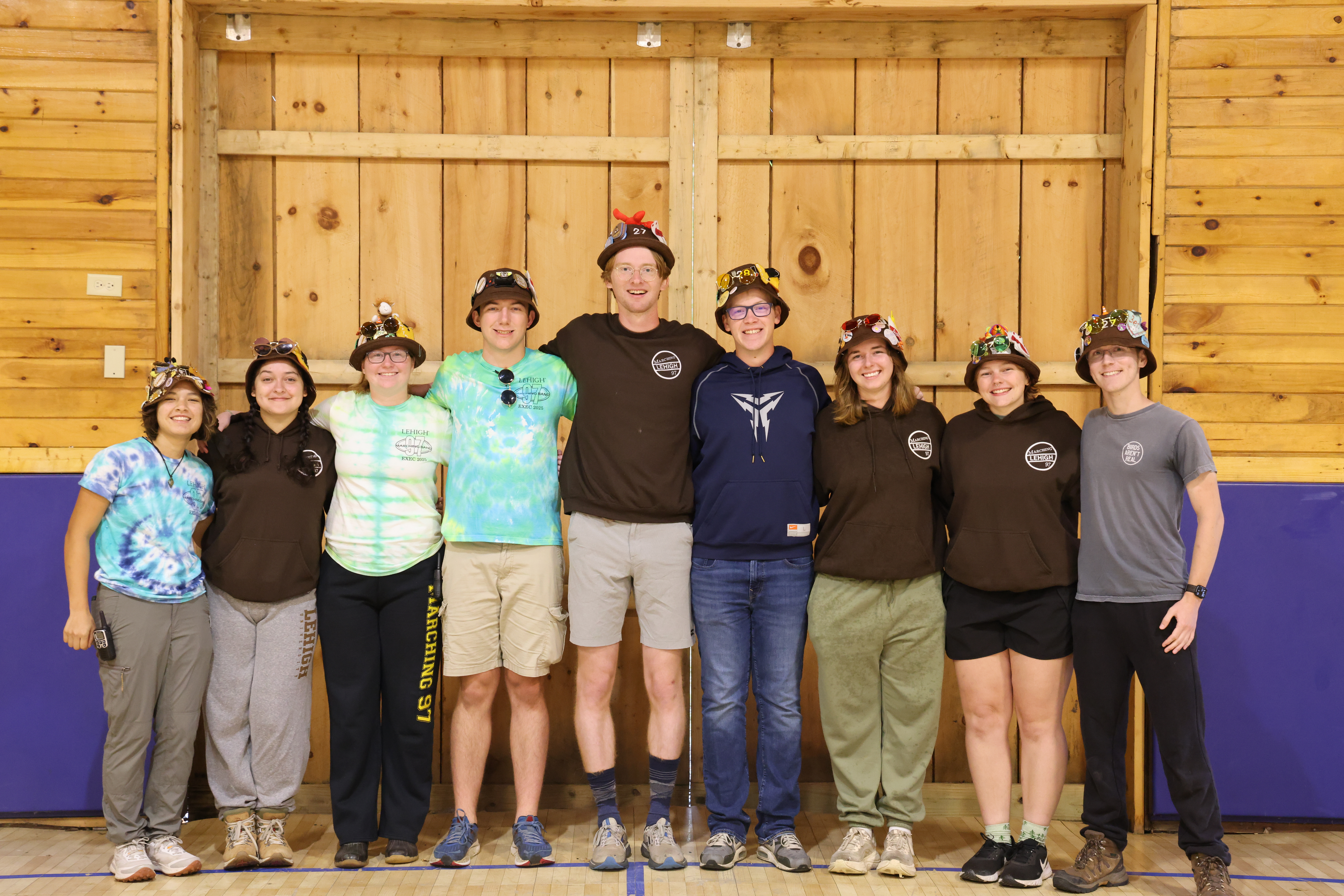Rank 5 smiling with their arms around each other at band camp.